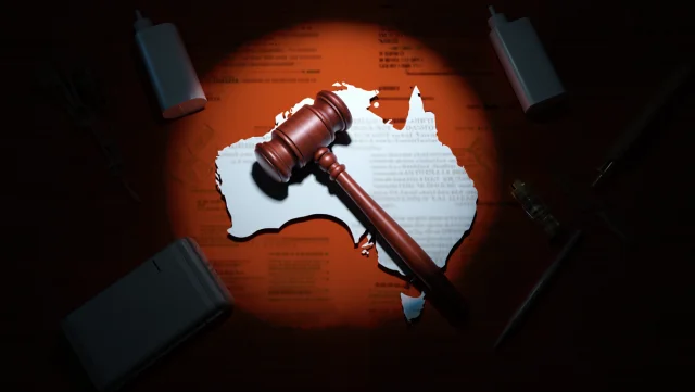 Conceptual image representing Australian vape regulations: a Gavel, a map of Australia, and vape icons under scrutiny.
